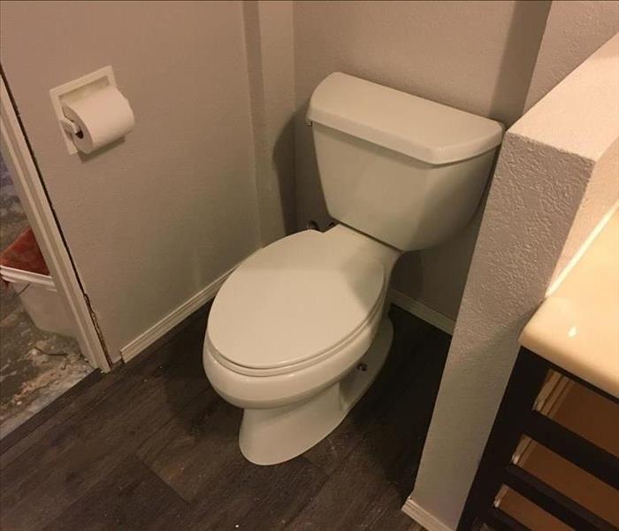 A new toilet in a residential bathroom. 